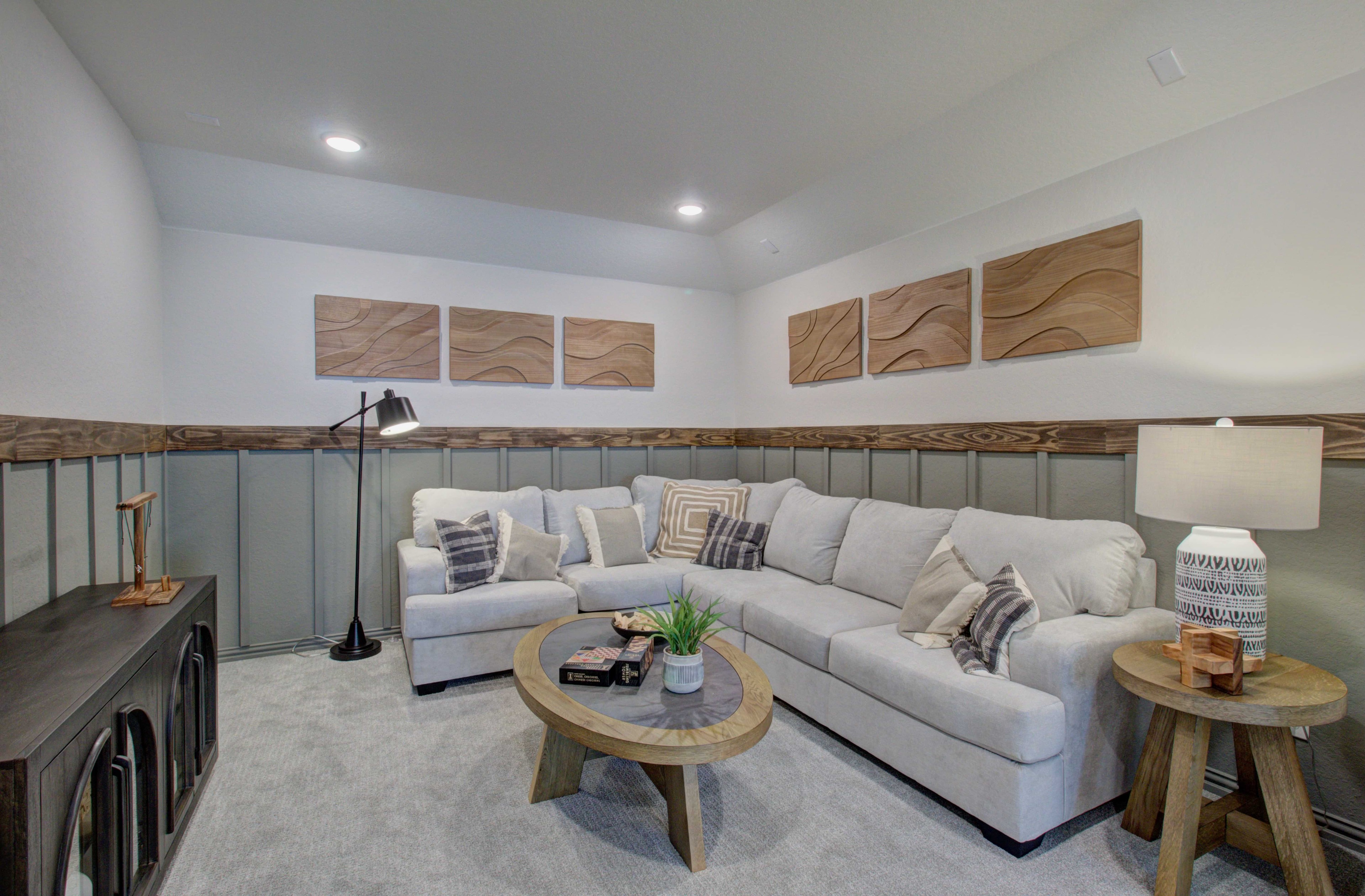Meyer Ranch Modern Living Room with Elegant Wainscoting Modern living room with sectional sofa, wood wall art, elegant wainscoting, in Meyer Ranch, Enclave community.