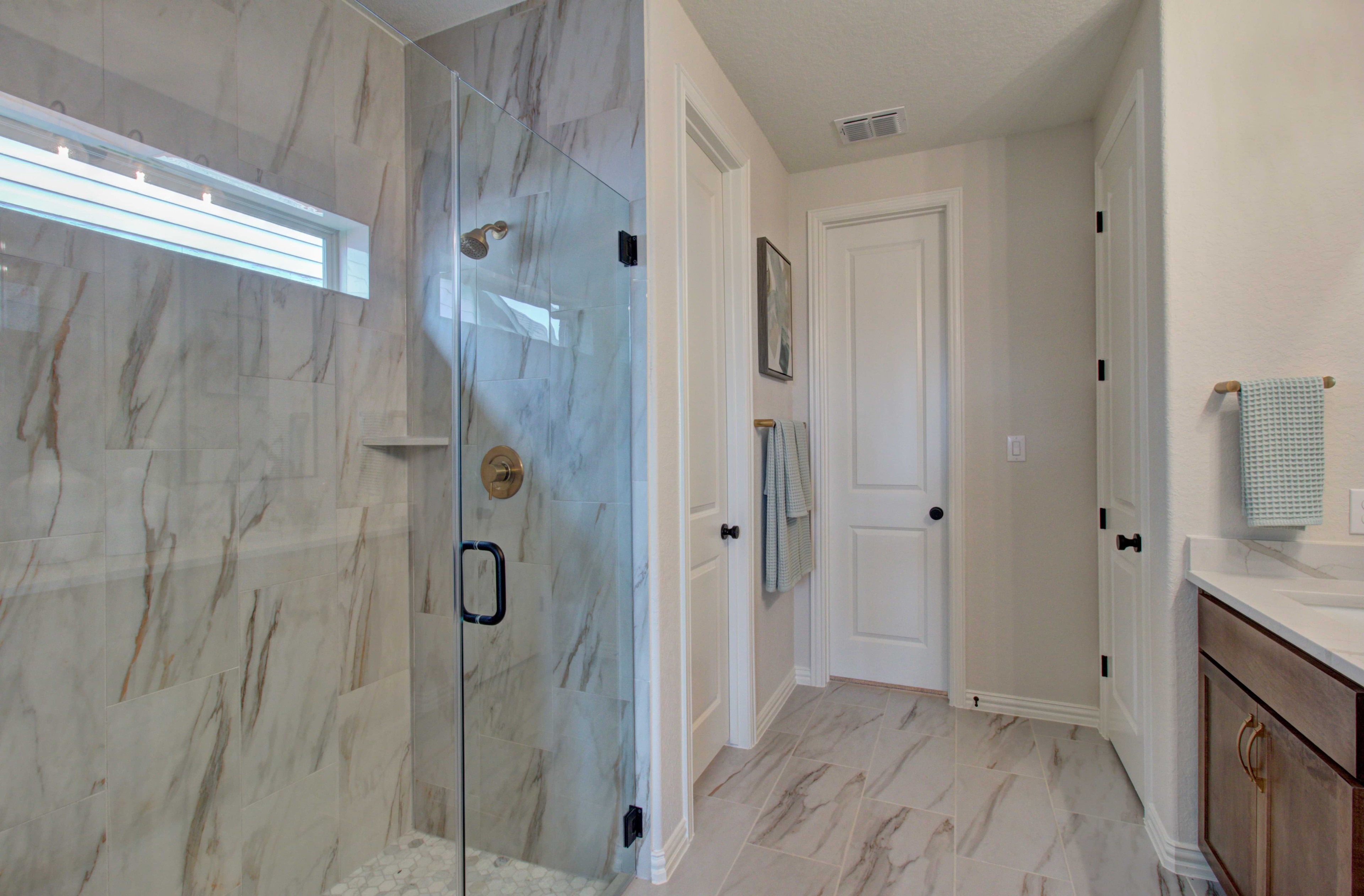 Marble-Tiled Bathroom in Meyer Ranch Enclave with Glass Shower Luxurious marble-tiled bathroom with glass shower and modern fixtures in Meyer Ranch, Enclave community.
