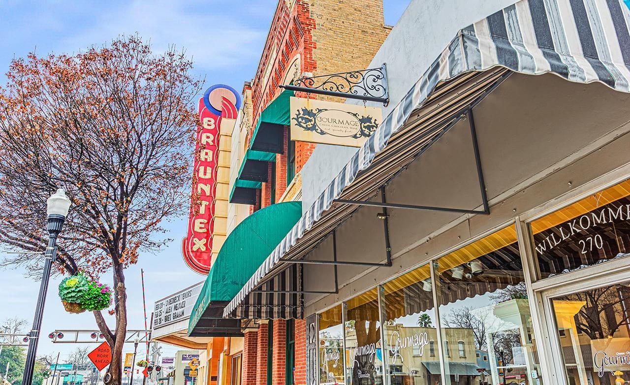 Brauntex Theatre Historic Facade New Braunfels Brauntex Theatre facade with vintage neon sign, brick architecture, and striped awnings in New Braunfels.