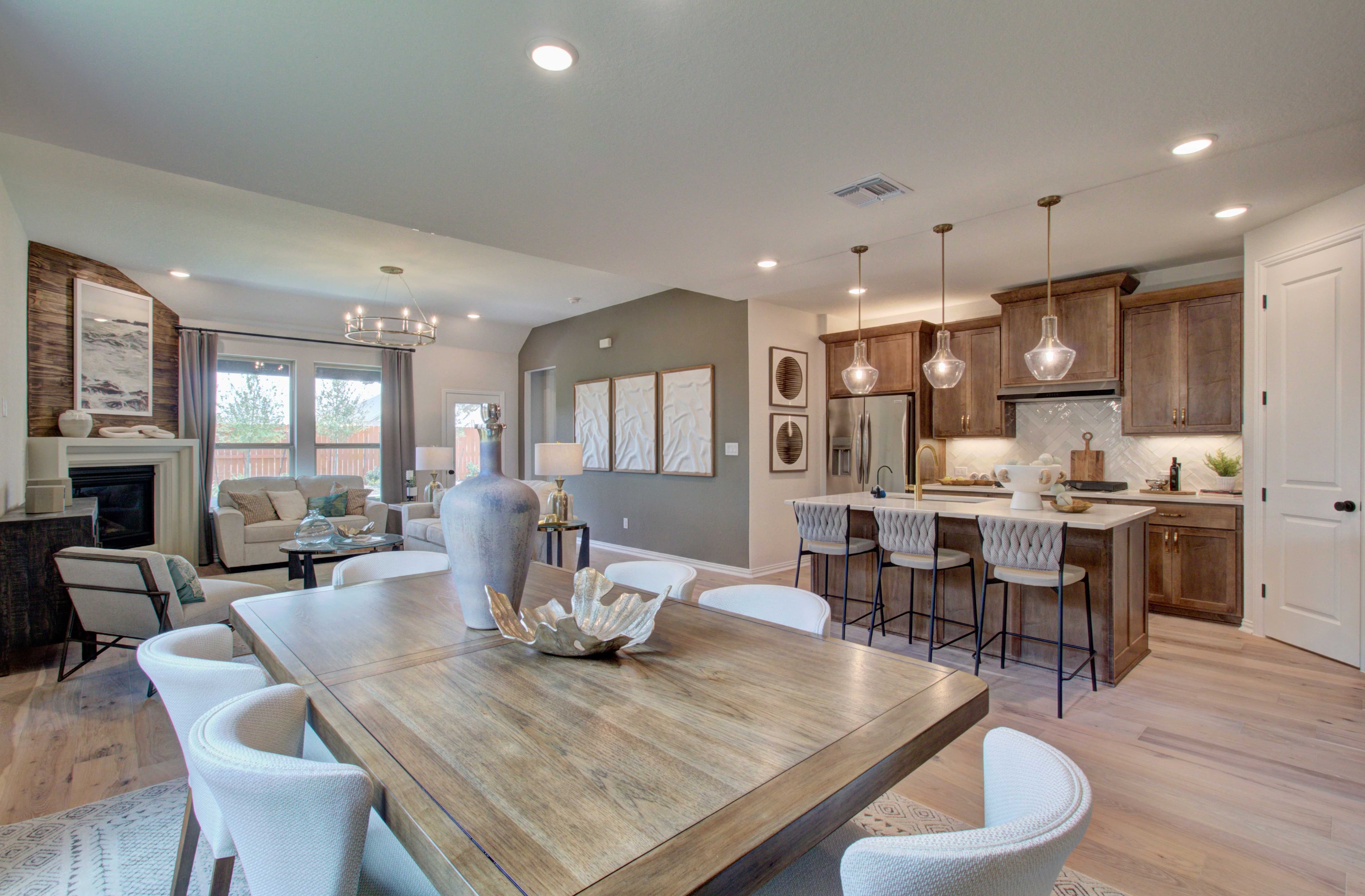 Open-Concept Living Area with Kitchen in Meyer Ranch Open-concept kitchen and living area with wood accents, modern lighting, and large windows in Meyer Ranch.