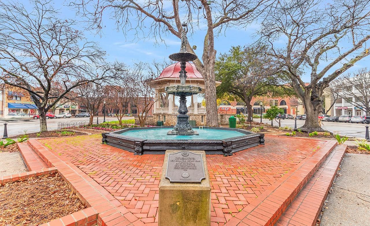 Fountain and Gazebo in Downtown Square Fountain in octagonal pool with nearby gazebo, surrounded by trees. Located in downtown square.