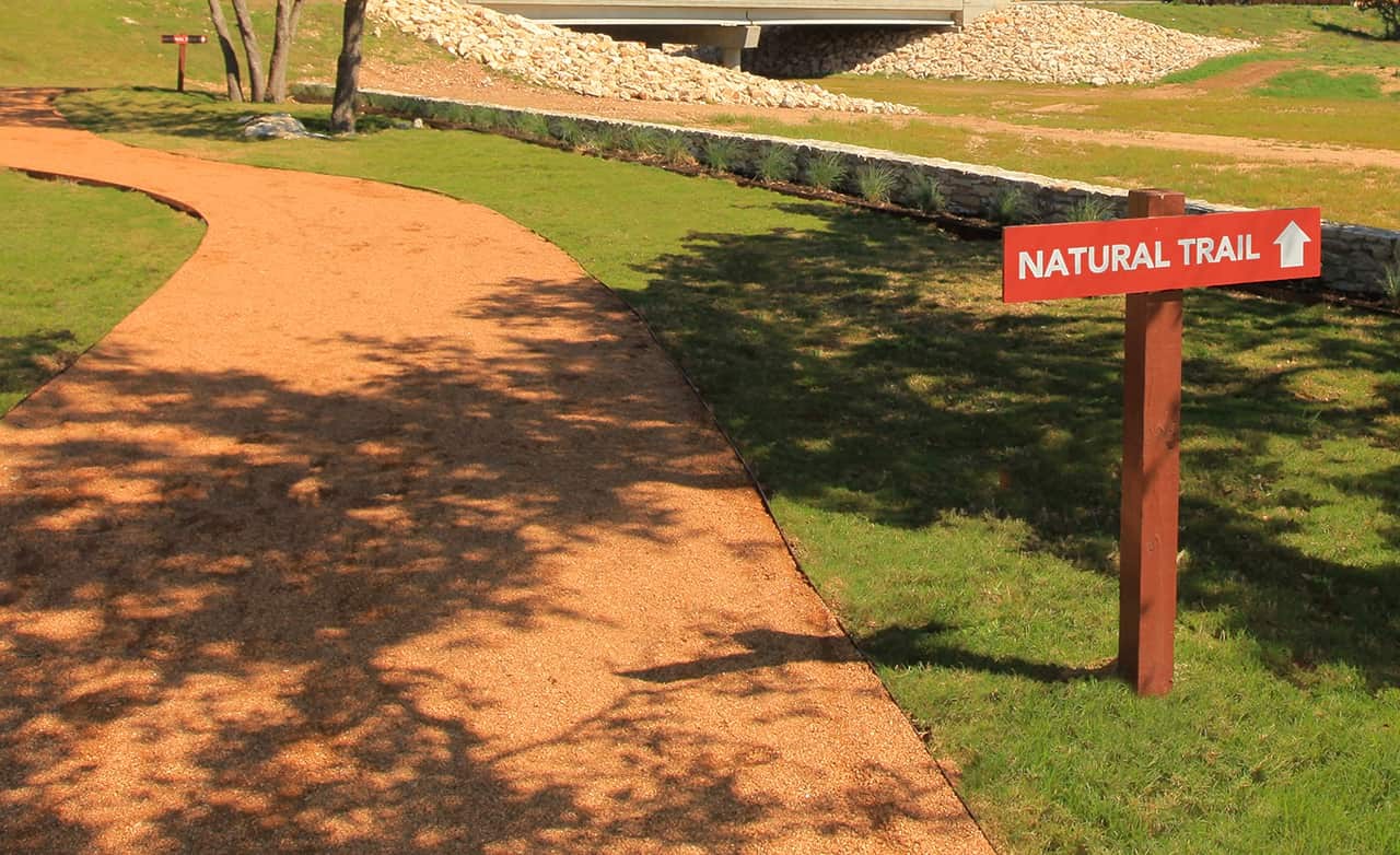 Natural Trail at Meyer Ranch, Enclave Community, Texas Natural trail with gravel path and sign at Meyer Ranch, Enclave community, Texas.