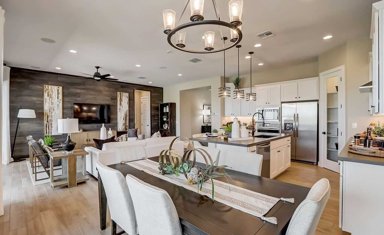 Open-Concept Living and Dining Room at Canyon Views, Hacienda Open-concept living-dining room features elegant lighting, white cabinetry, wood accents at Canyon Views, Hacienda.