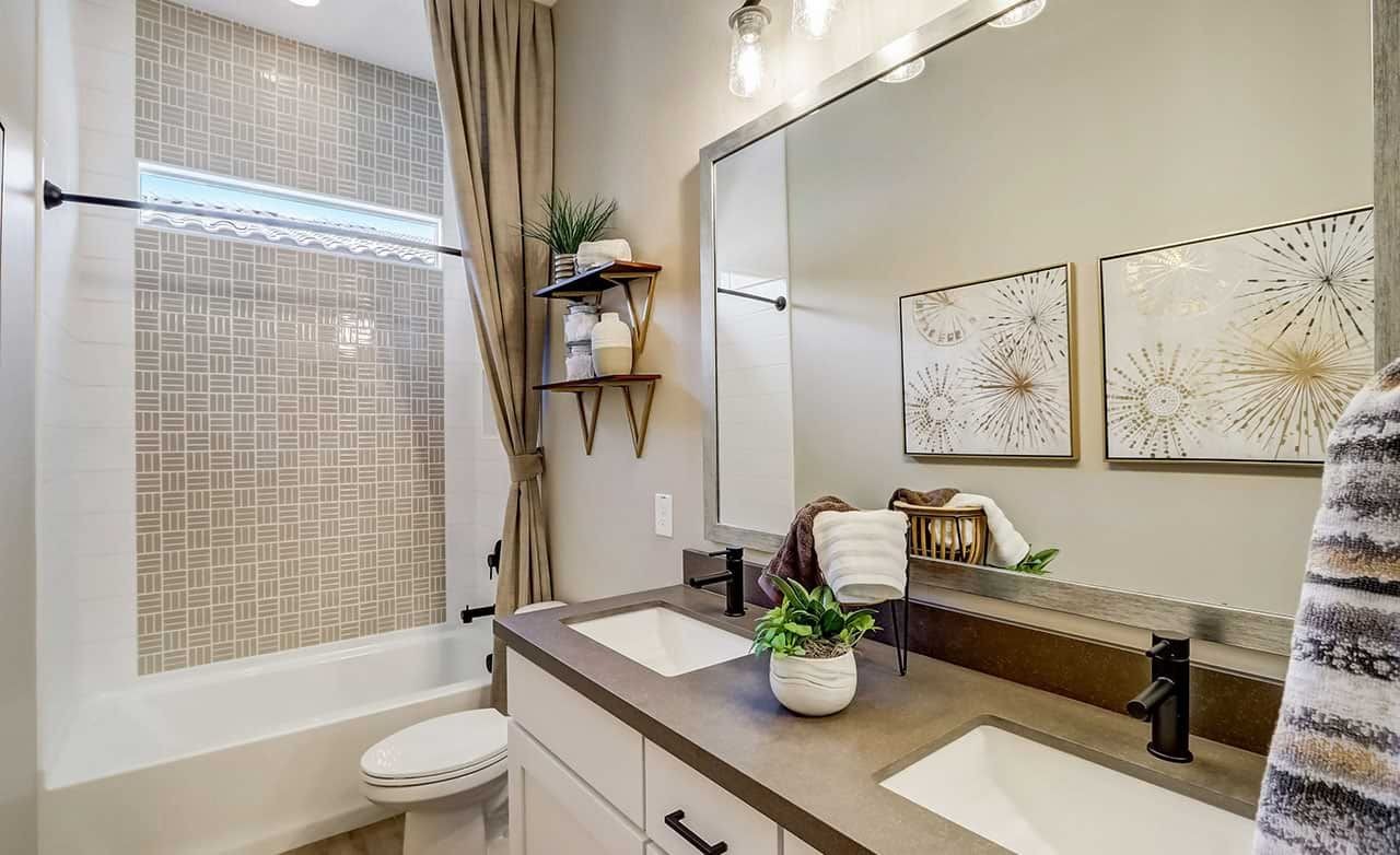 Luxurious Bathroom Design in Canyon Views Hacienda Community Elegant bathroom with dual vanity, geometric tile, and modern fixtures in Canyon Views Hacienda community.