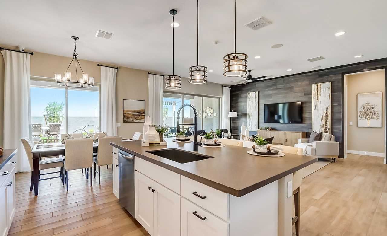 Canyon Views Hacienda Modern Kitchen and Living Room Interior Modern kitchen and living room with wood floors, pendant lights, large windows in Canyon Views Hacienda community.