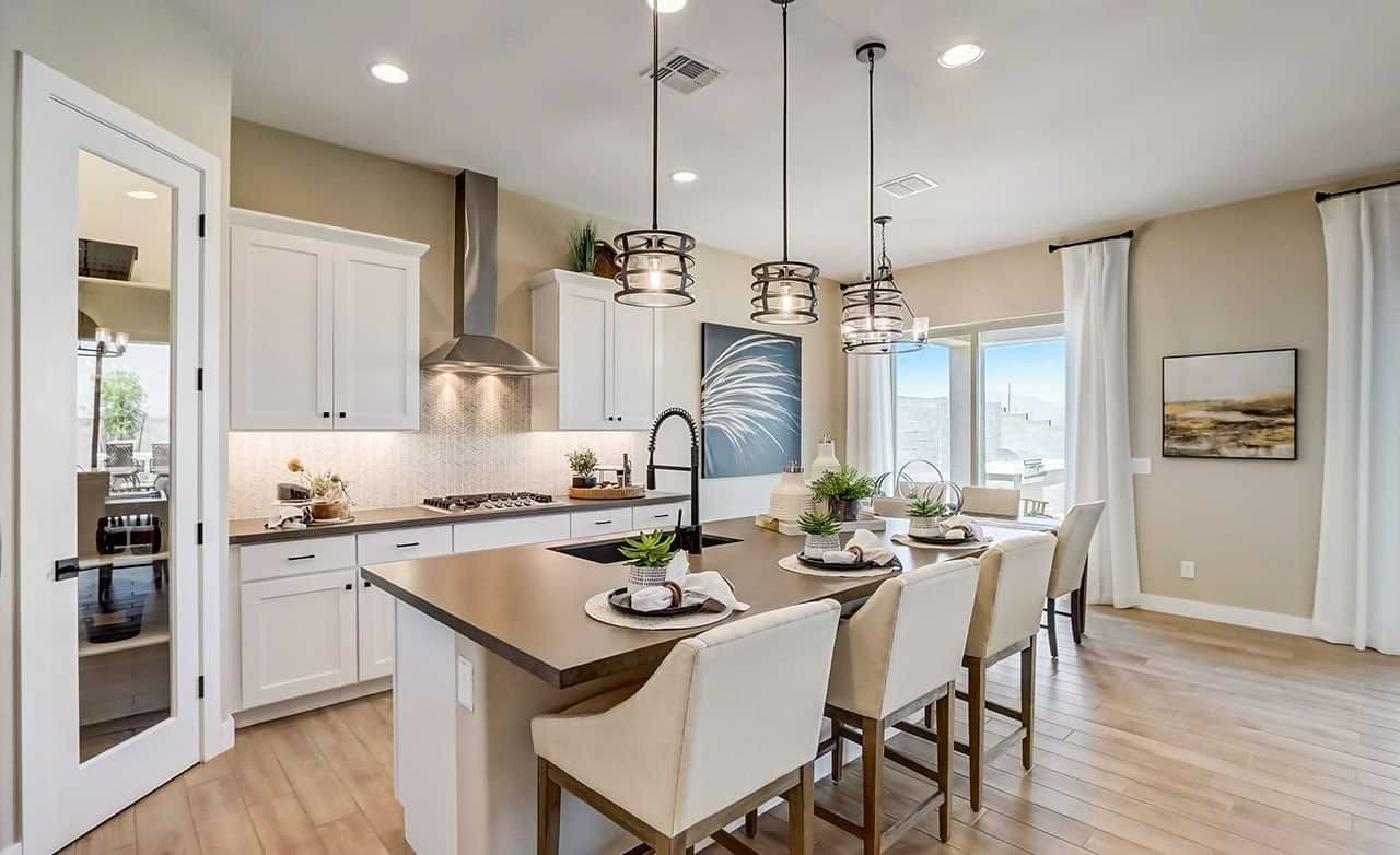 Modern Kitchen with Island in Hacienda Home at Canyon Views Modern kitchen in Hacienda home featuring pendant lights, island, and panoramic windows in Canyon Views community.