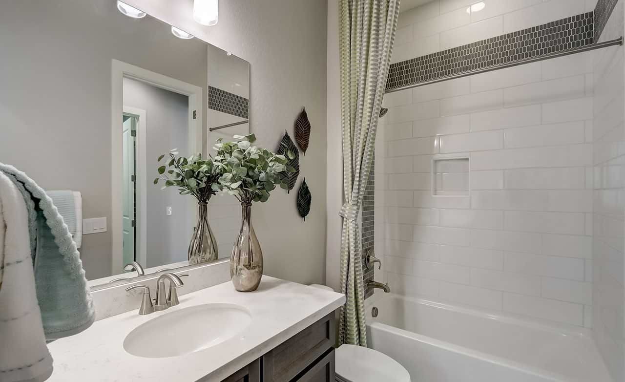 Luxury Bathroom Design at Canyon Views Hacienda Luxurious bathroom with white tiles, elegant fixtures, glass vases; Canyon Views, Hacienda.