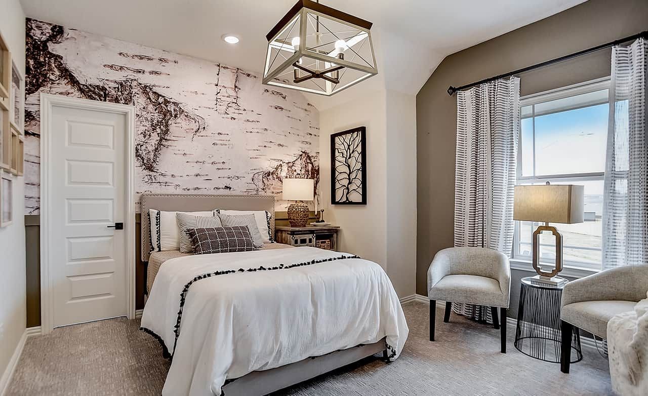 Luxurious Bedroom with Modern Design at Casinas at Gruene Elegant bedroom with abstract wall art, plush bedding, modern chandelier, and large window in Casinas at Gruene.