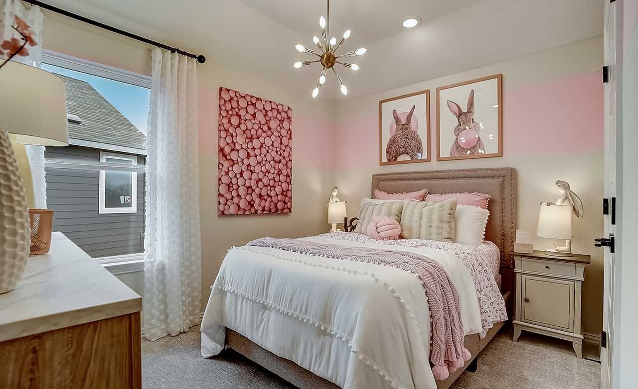 Bedroom with Pink Decor and Modern Lighting in Casinas at Gruene Stylish bedroom with modern chandelier, pink accents, and art in Casinas at Gruene. Elegant and cozy interior.