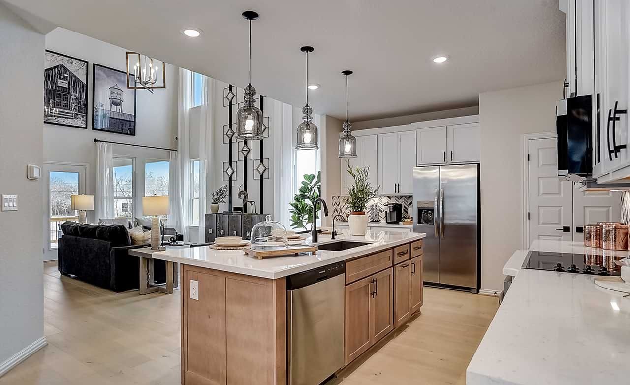 Modern Kitchen Design at Casinas at Gruene with Island and Pendant Lights Modern kitchen in Casinas at Gruene. Features island, pendant lights, high ceilings, and stainless appliances.