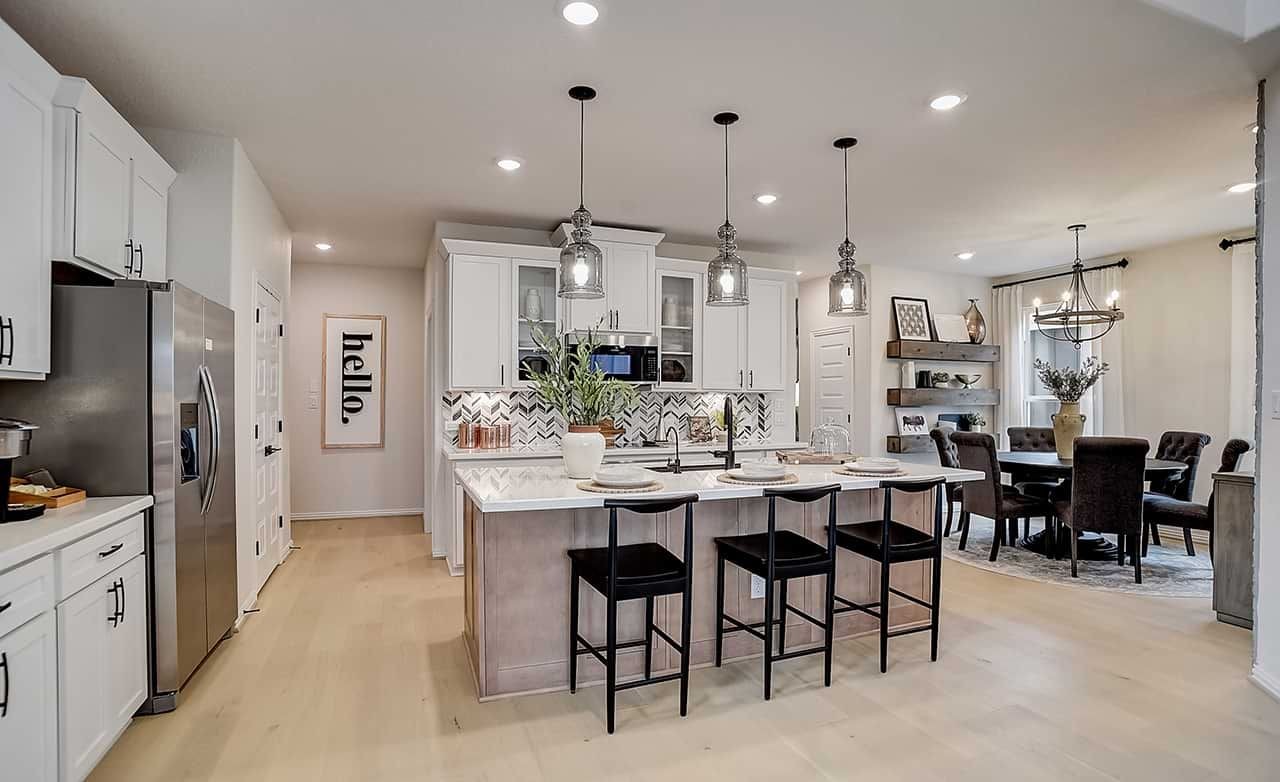 Luxury Kitchen Design in Casinas at Gruene Home Modern kitchen in luxury home, Casinas at Gruene. Features chic lighting, herringbone backsplash, open layout.