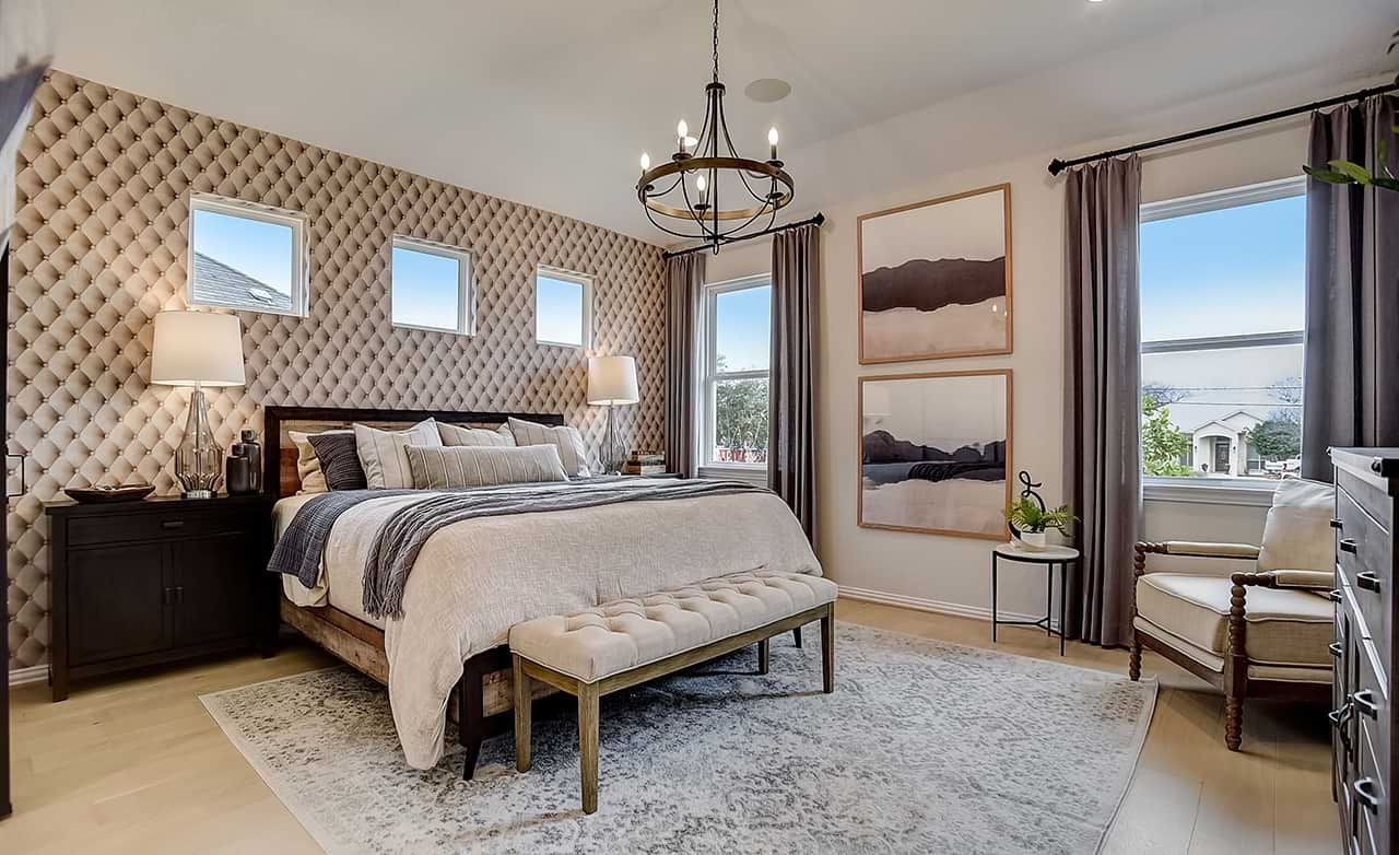Luxury Bedroom with Tufted Wall in Casinas at Gruene, Texas Elegant bedroom with tufted wall, chandelier, and modern decor in Casinas at Gruene, Texas.