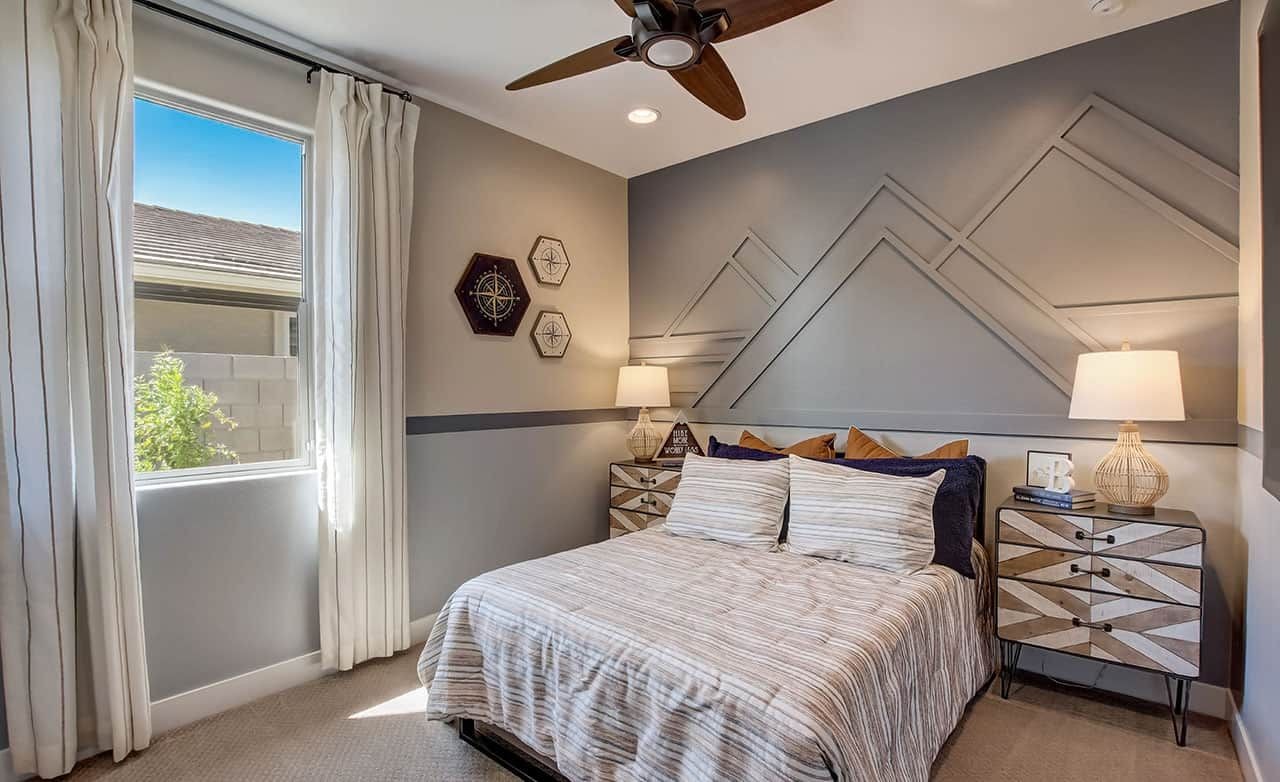 Castillo at Anderson Parc Bedroom with Geometric Wall Design Modern bedroom in Castillo at Anderson Parc with geometric accent wall and unique side tables.
