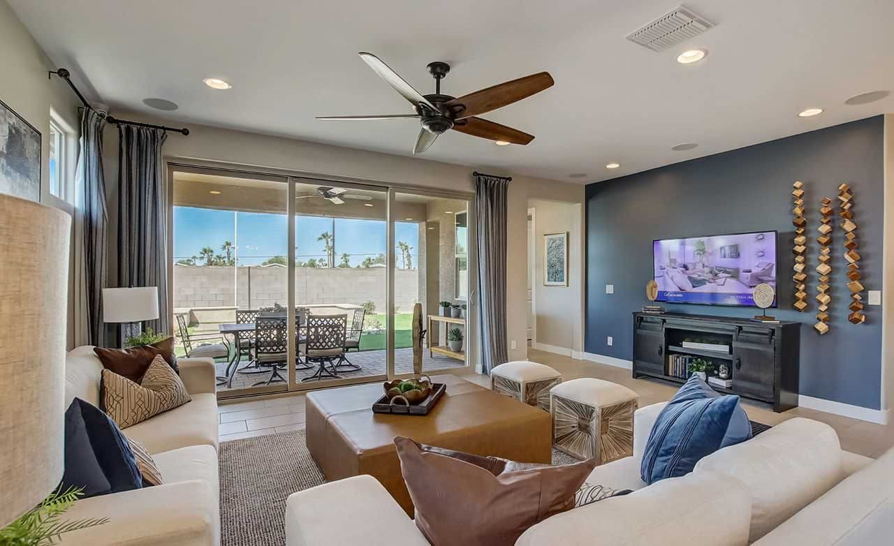 Elegant Living Room at Castillo, Anderson Parc Community Luxurious living room with ceiling fan, sliding glass doors, modern decor at Castillo, Anderson Parc.