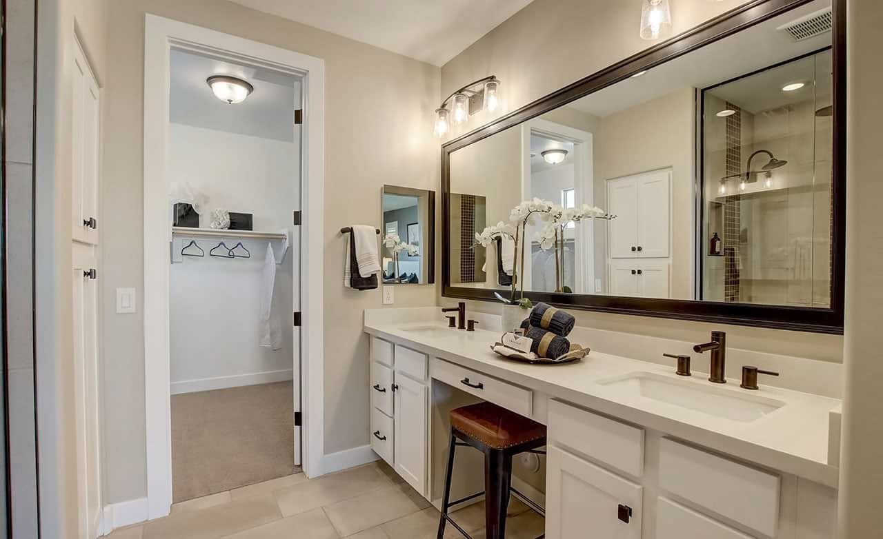 Luxurious Bathroom with Dual Sinks at Anderson Parc Elegant bathroom with dual sinks, large mirror, bronze fixtures in Anderson Parc. Modern, spacious design.