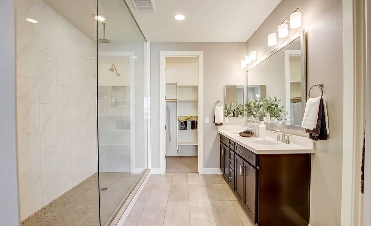 Luxury Bathroom with Glass Shower in Anderson Parc Elegant bathroom with glass shower, double vanity, and large mirror in Anderson Parc home.