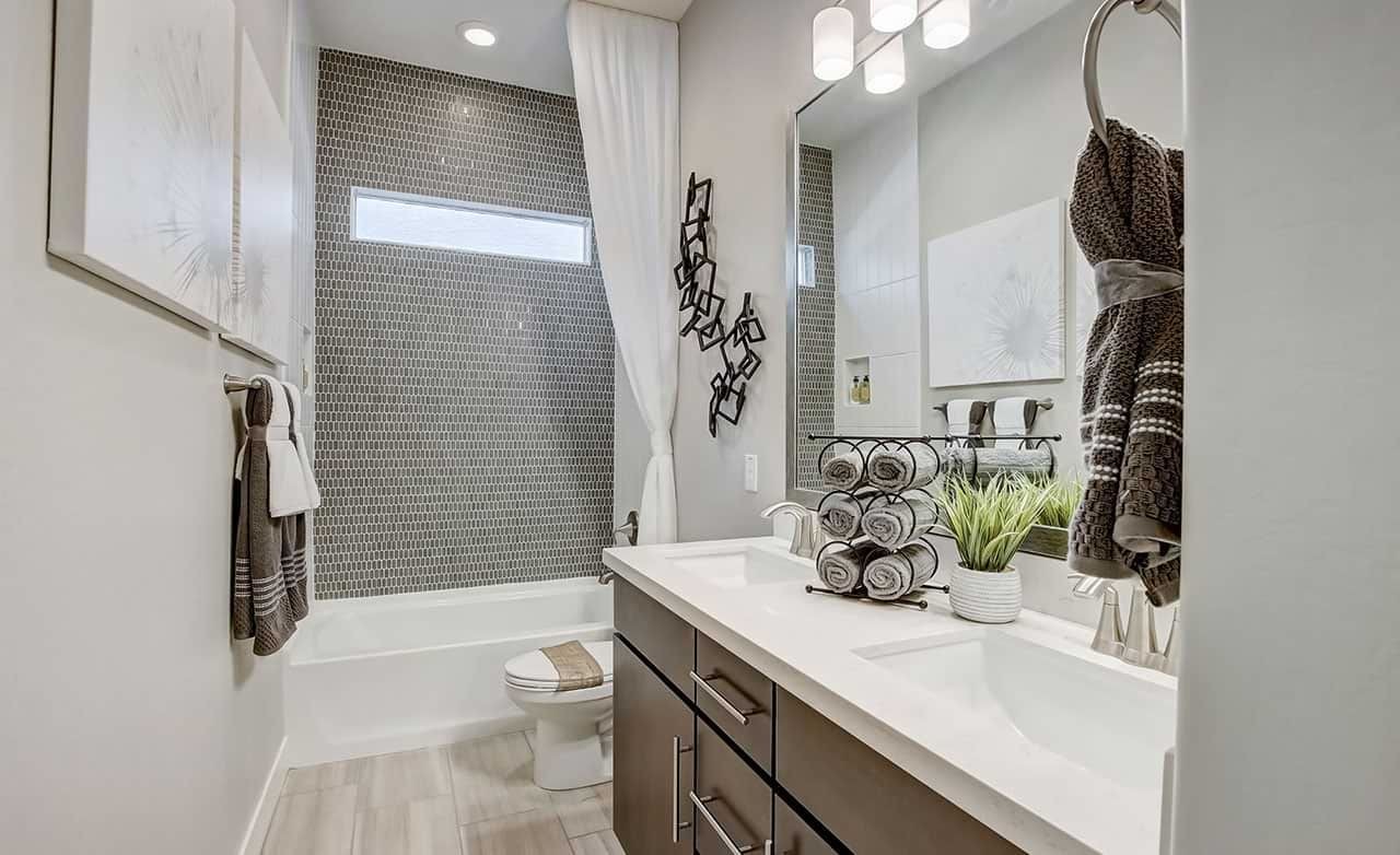 Contemporary Bathroom Design at Mirada Crossing Elegant bathroom with mosaic tile wall, sleek vanity, and modern lighting at Mirada Crossing.
