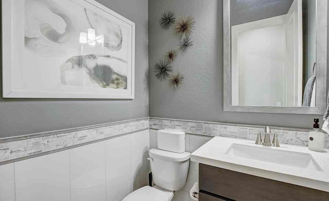 Modern Bathroom Design with Abstract Art - Mirada Crossing Modern bathroom with abstract art, elegant fixtures, and designer tiles in Mirada Crossing.