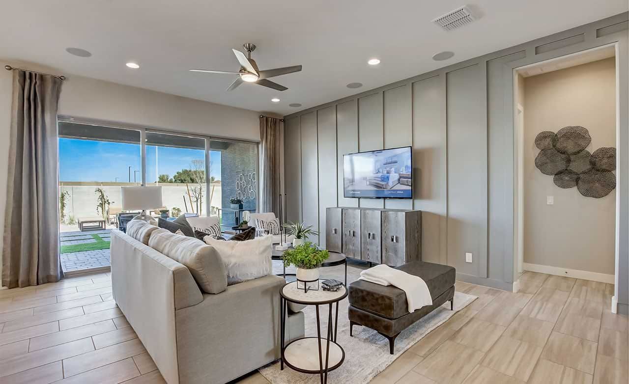 Modern Living Room with Paneled Walls in Mirada Crossing Modern living room with paneled walls, large windows, and sleek decor in Mirada Crossing community.