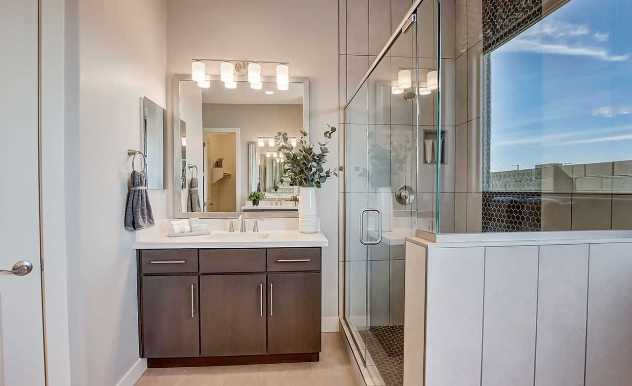Mirada Crossing Bathroom with Glass Shower and Vanity Modern bathroom with glass shower, dark wood vanity, large mirror, in Mirada Crossing.