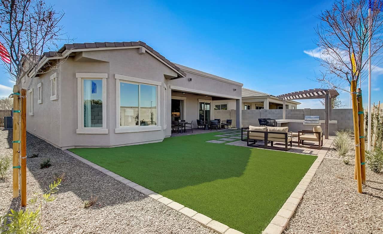 Backyard with Pergola and Patio in Mirada Crossing Community Modern backyard with pergola, paved patio, and artificial grass in Mirada Crossing community. Clear sky backdrop.