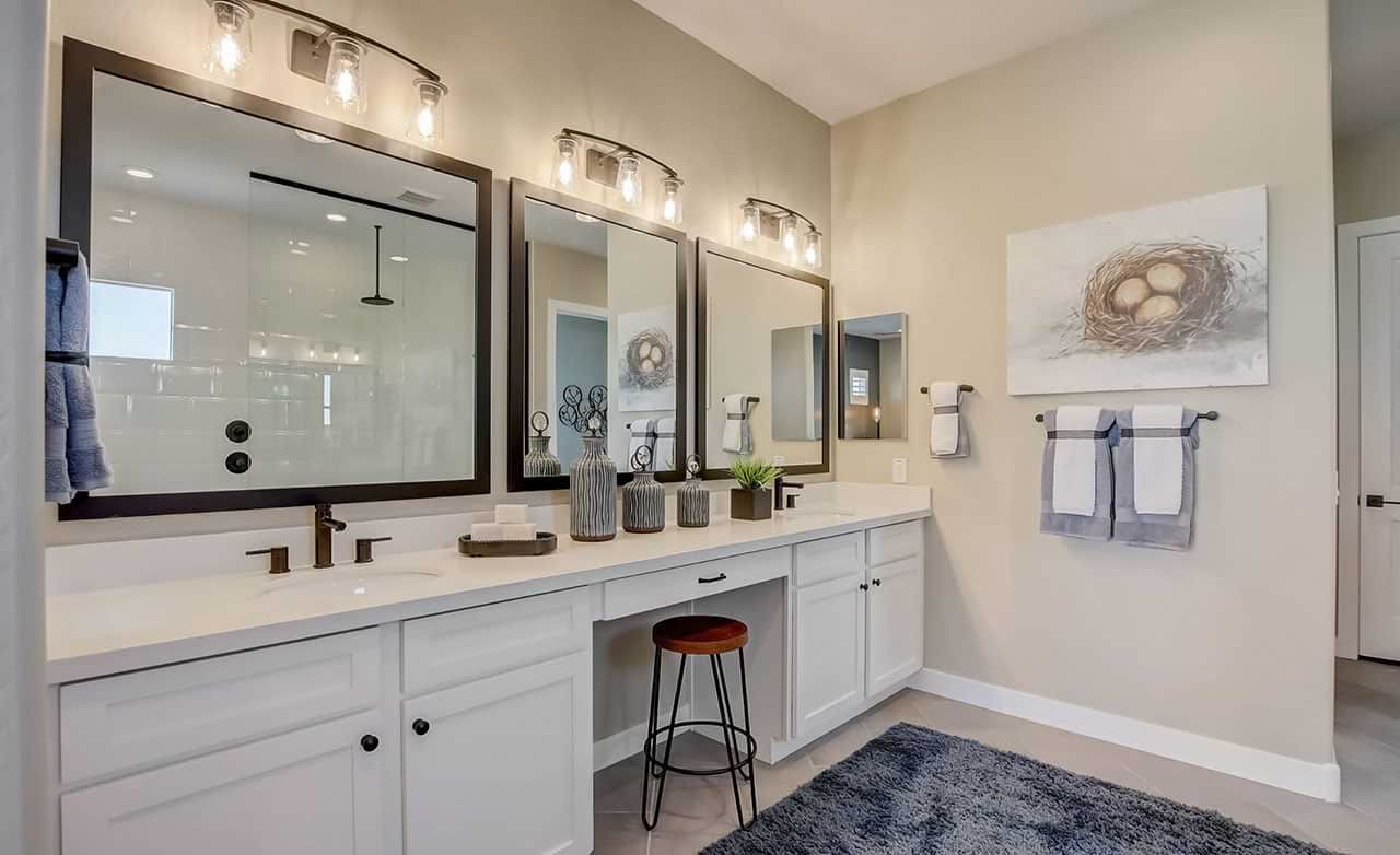 Mirada Crossing Bathroom with Dual Vanity and Modern Fixtures Luxurious bathroom with dual vanity, framed mirrors, and modern lighting at Mirada Crossing.