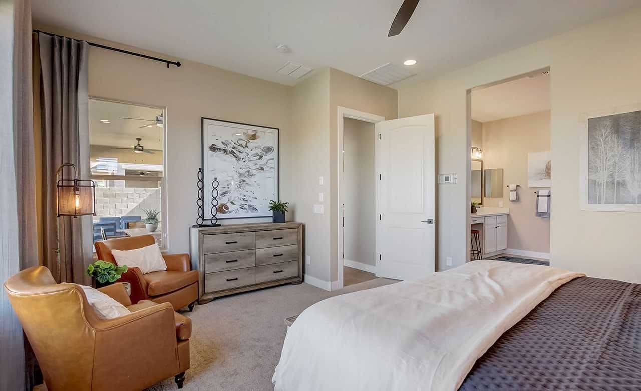 Mirada Crossing Bedroom with Leather Chairs and Art Elegant bedroom in Mirada Crossing, featuring leather chairs, modern art, and en-suite bathroom.