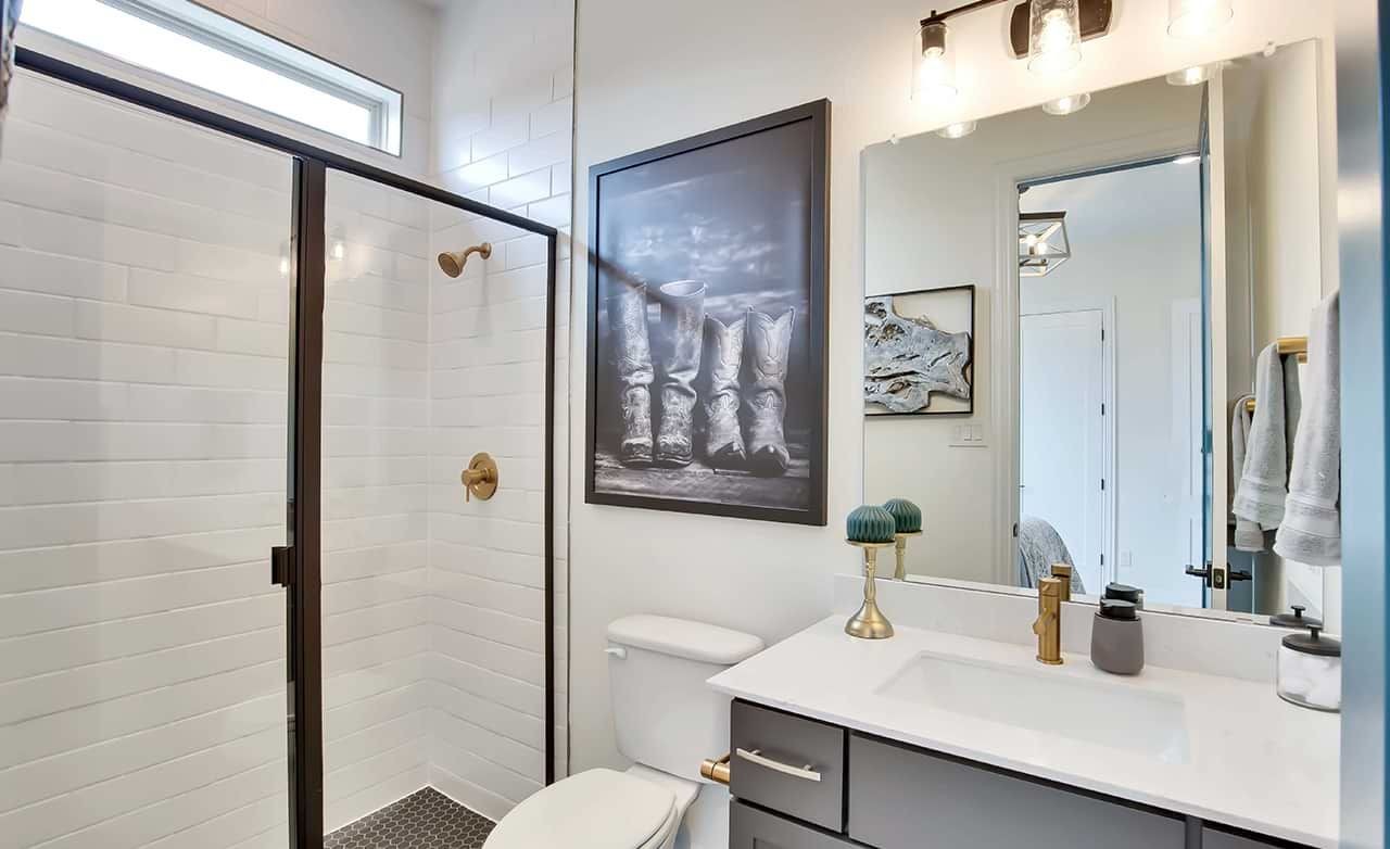 Modern Bathroom Design in Oaks at San Gabriel Modern bathroom with glass shower, sleek vanity, and decor accents in Oaks at San Gabriel.