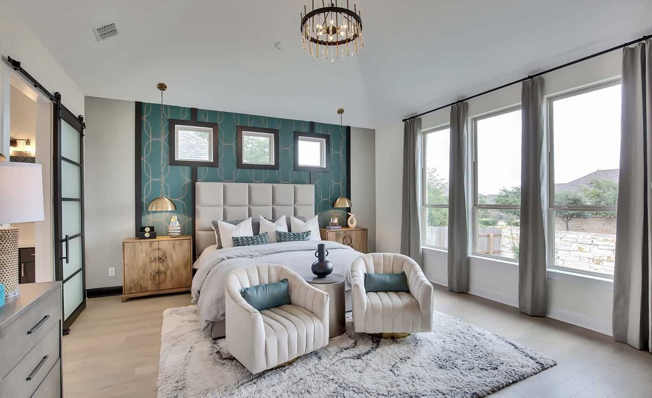 Luxurious Bedroom Design in Oaks at San Gabriel, Texas Elegant bedroom with large windows, modern chandelier, and plush decor in Oaks at San Gabriel, Texas.