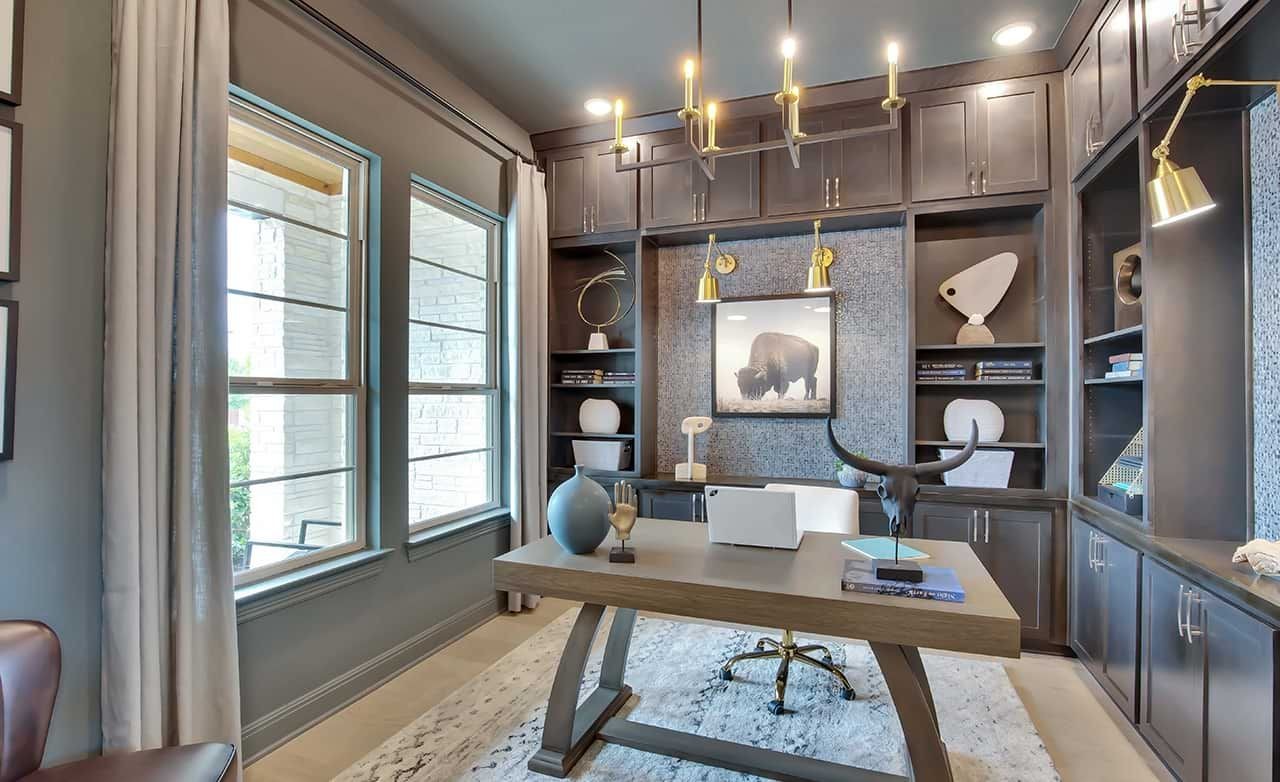 Elegant Home Office with Built-ins, Oaks at San Gabriel, Texas Luxurious home office with dark wood built-ins, modern chandelier, in Oaks at San Gabriel, Texas.