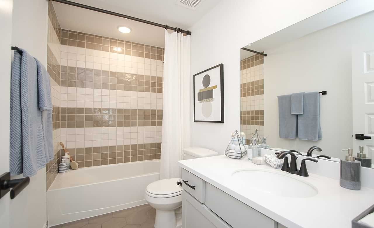 Oakwood Estates Modern Bathroom with Hexagonal Tiles Modern bathroom with hexagonal floor tiles and geometric art in Oakwood Estates.