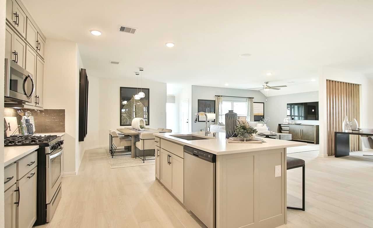 Open-Plan Kitchen and Living Area in Oakwood Estates Home Modern open-plan kitchen and living area with light wood cabinets, island, and dining table in Oakwood Estates.