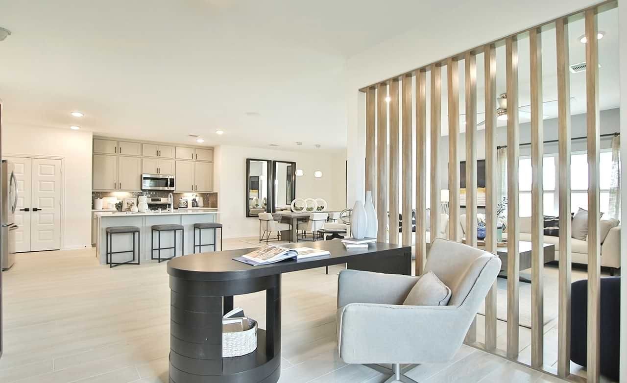 Oakwood Estates Modern Kitchen and Living Room Interior Oakwood Estates luxury open-plan kitchen and living room with wood slat divider, modern furnishings.