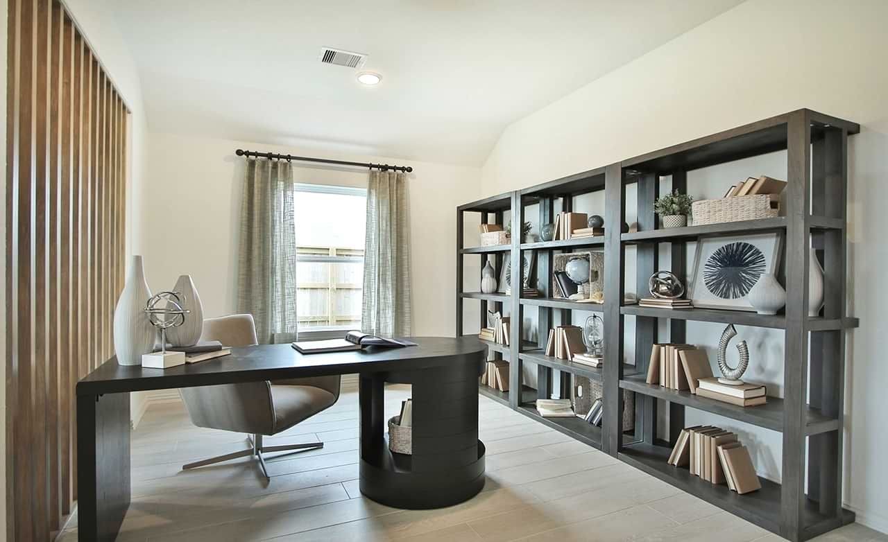 Contemporary Home Office Design at Oakwood Estates Modern home office with sleek black desk, wooden slat accent wall, and large bookshelves at Oakwood Estates.