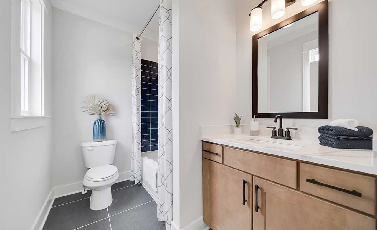 Modern Bathroom with Wood Vanity in Richvale Estates Elegant bathroom with wood vanity, black fixtures, and blue tile in Richvale Estates.