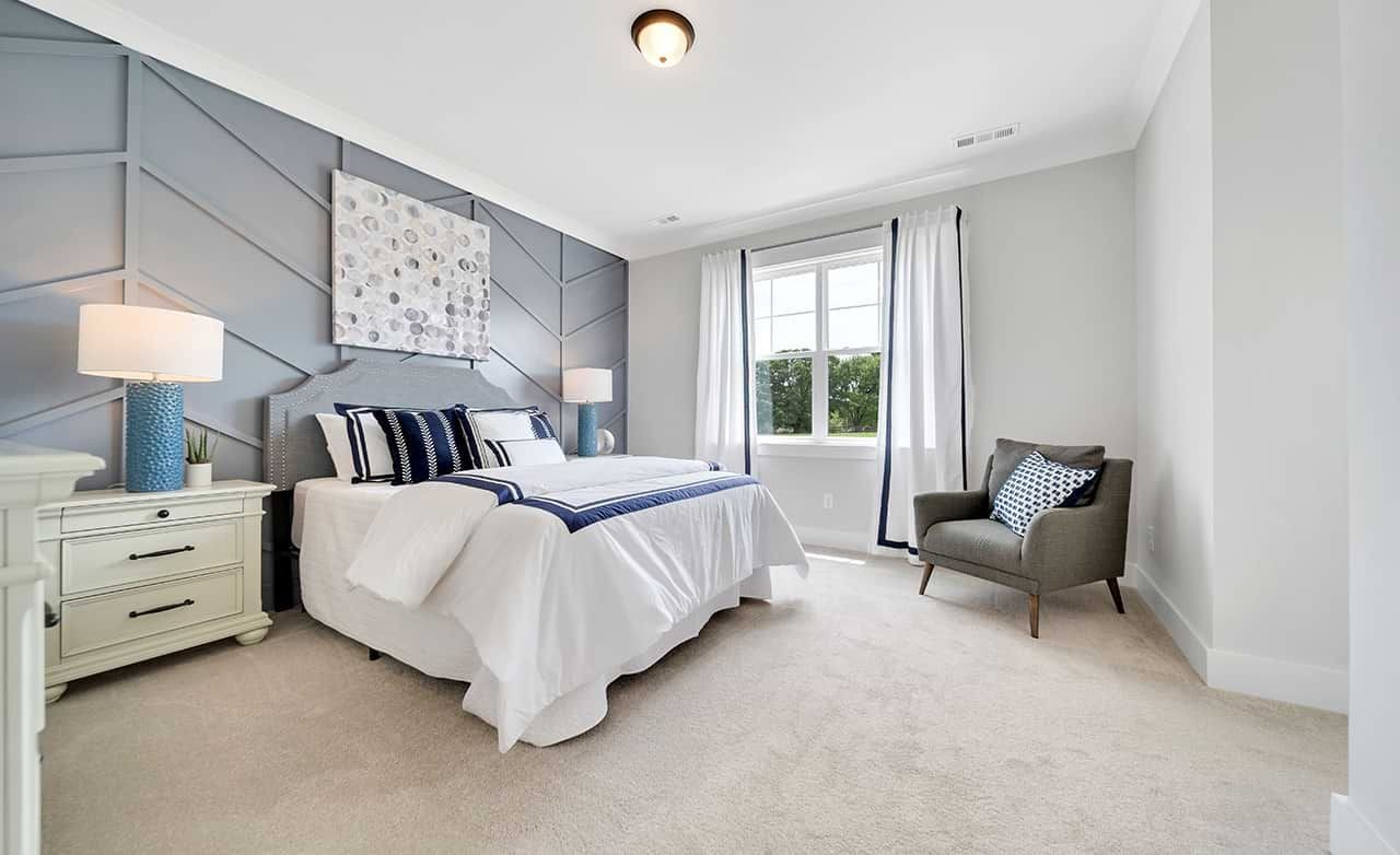 Sophisticated Bedroom Design in Richvale Estates with Geometric Wall Modern bedroom in Richvale Estates with geometric accent wall, large window, and elegant furniture.