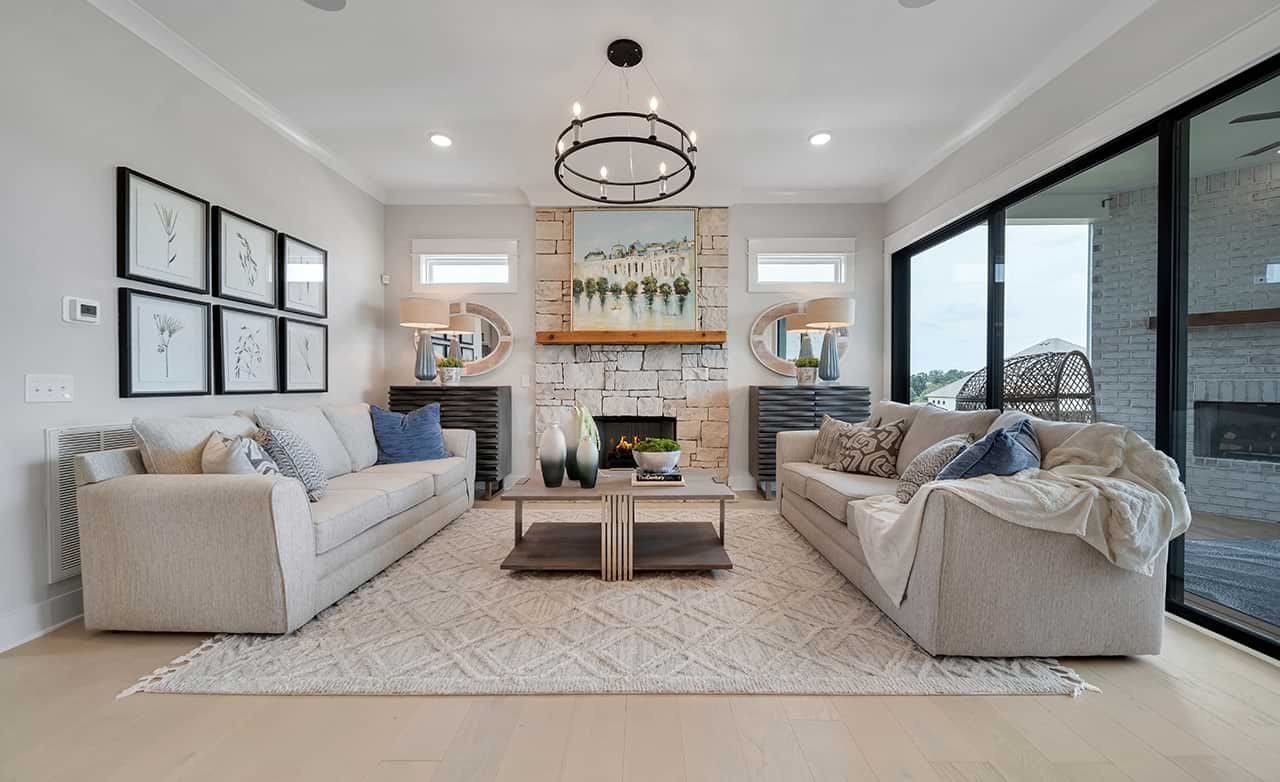 Luxurious Living Room in Richvale Estates with Stone Fireplace Elegant living room in Richvale Estates with stone fireplace, plush sofas, and large windows.