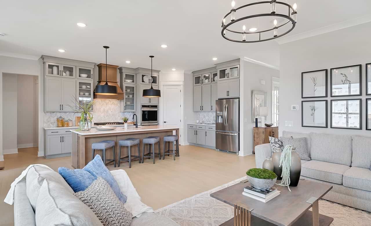 Modern Kitchen-Living Space in Richvale Estates Modern kitchen-living area with gray cabinets, island, pendant lights, and chic decor in Richvale Estates.