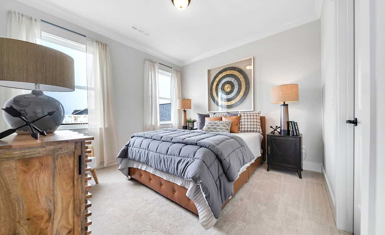 Modern Bedroom Design in Richvale Estates with Large Windows Modern bedroom with large windows, elegant decor, and gray bedding in Richvale Estates.