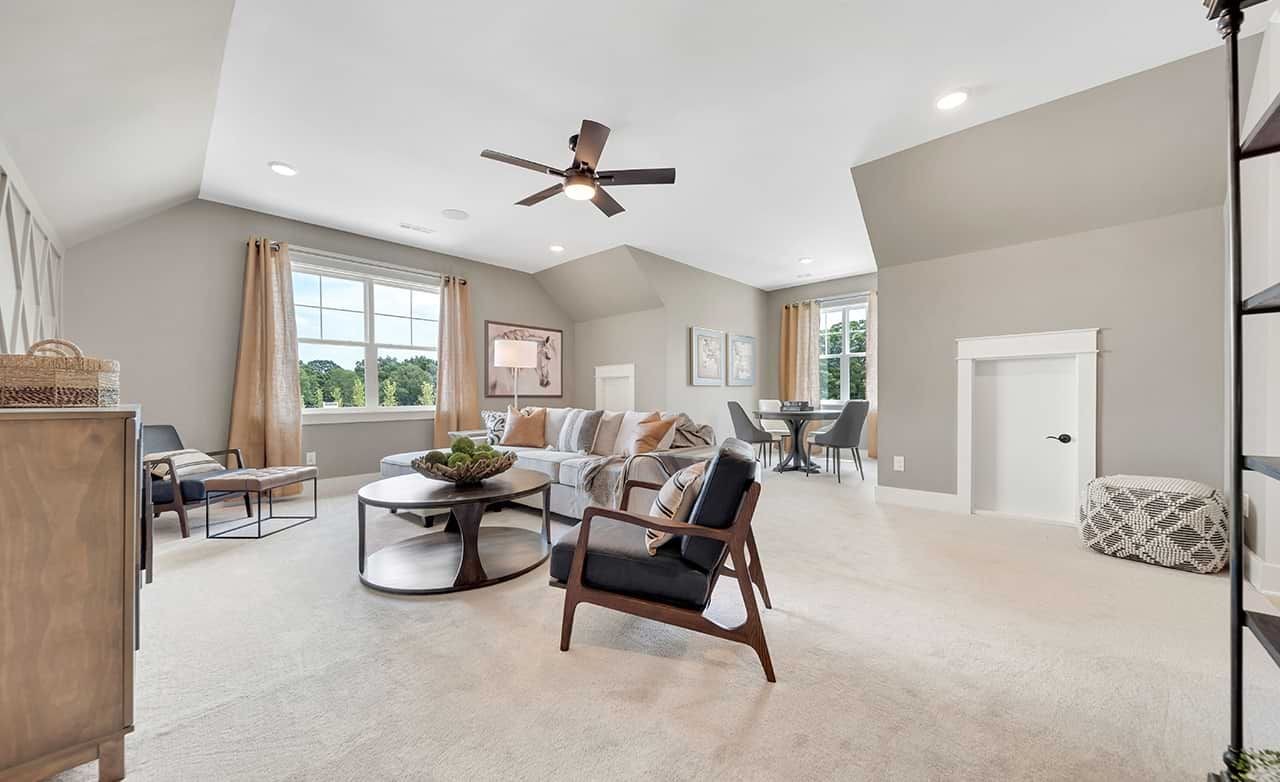 Stylish Living Room in Richvale Estates Featuring Modern Decor Elegant living area with neutral tones, large window, stylish furniture, ceiling fan in Richvale Estates.