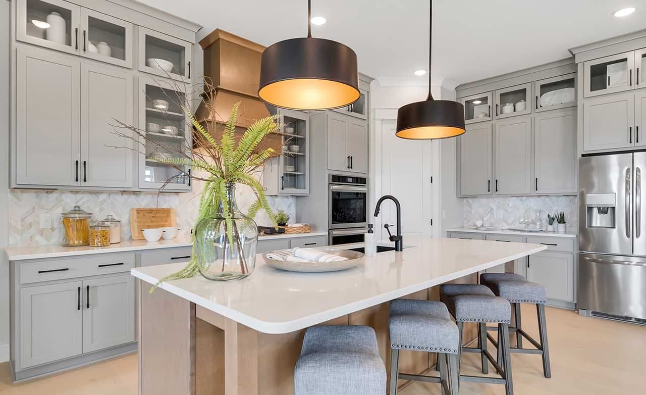 Modern Kitchen Design in Richvale Estates with Island and Gray Cabinets Modern kitchen with gray cabinets, marble backsplash, large island, pendant lights in Richvale Estates.