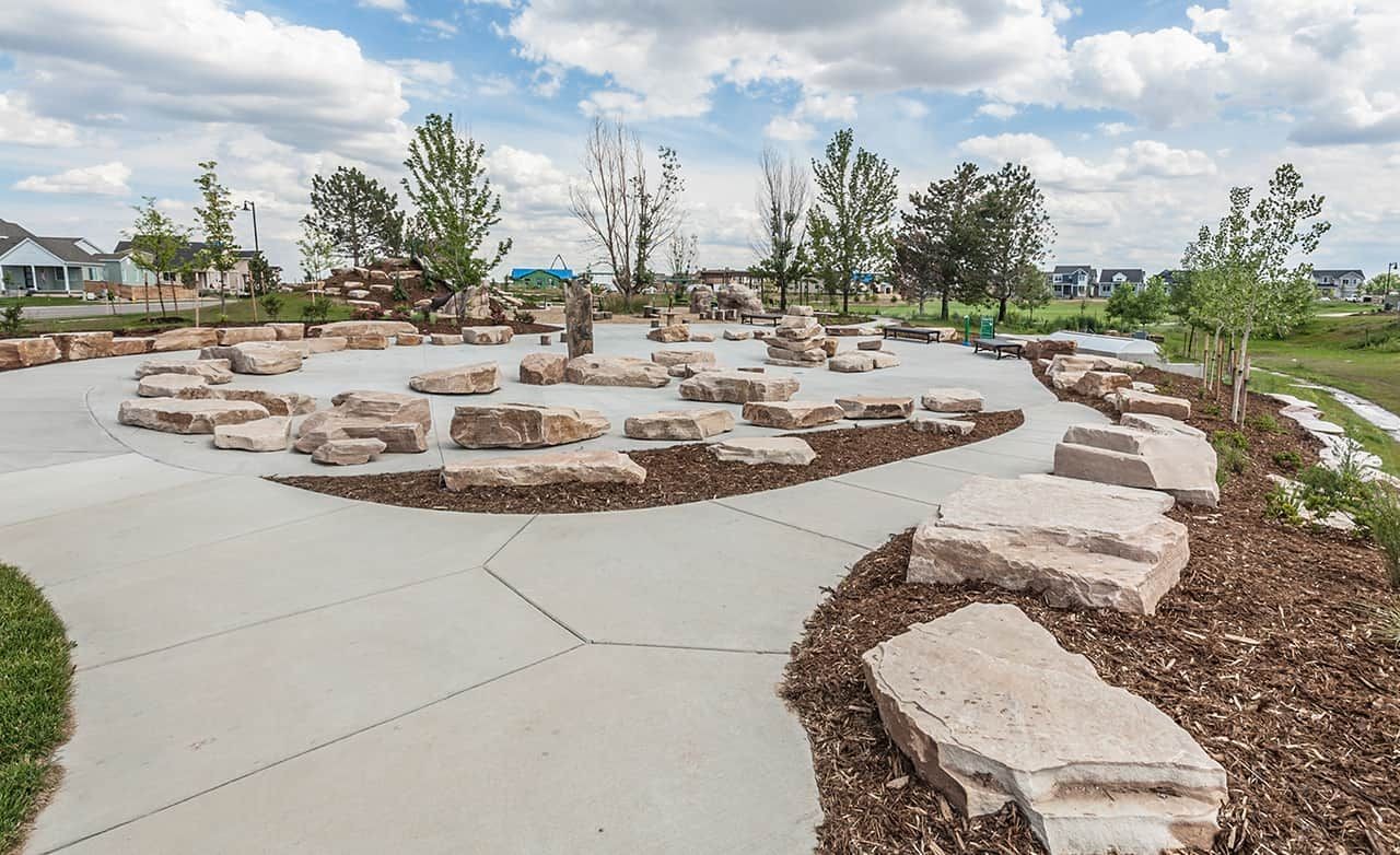 Trailside on Harmony Community Park with Stone Features, Colorado Community park with natural stone seating and pathways in Trailside on Harmony, Colorado. Scenic landscaping enhances charm.