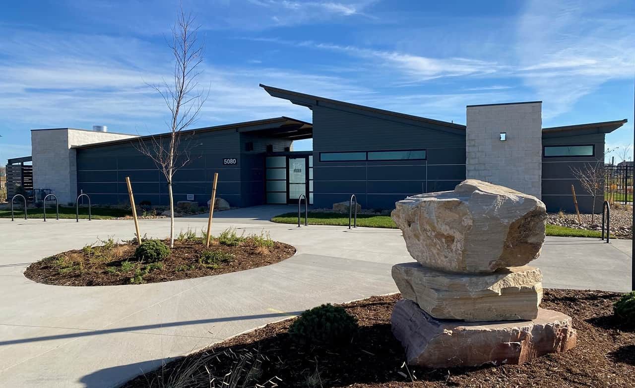 Modern Architectural Building in Trailside on Harmony Modern building with large windows, stone accents, and angular roofline in Trailside on Harmony.