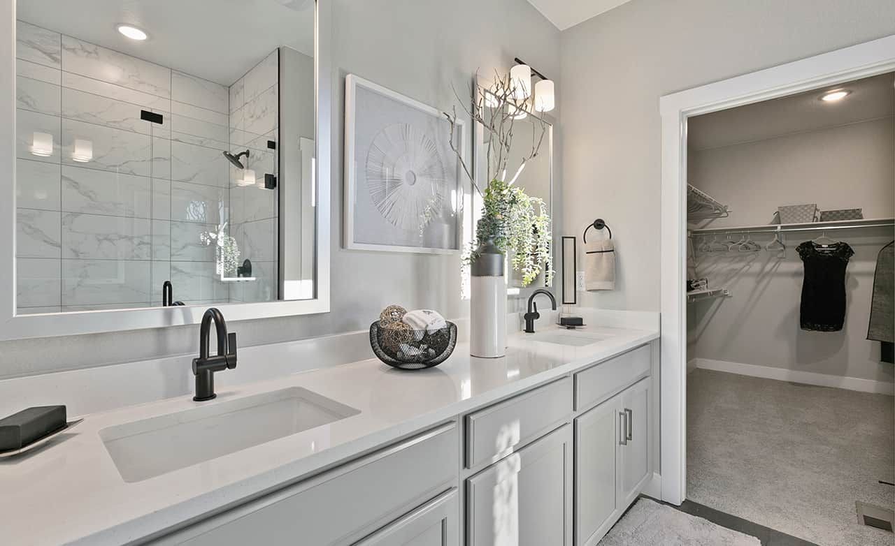 Luxury Bathroom with Marble and Walk-in Closet in Trailside on Harmony Modern bathroom with marble shower, dual sinks, walk-in closet in Trailside on Harmony community.