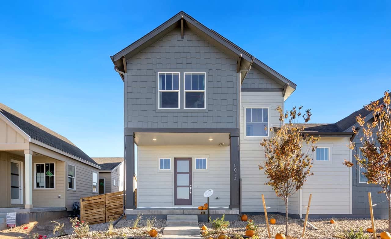 Modern Two-Story Home at Trailside on Harmony, Colorado Modern two-story house with gable roof, subtle grey siding, near Trailside on Harmony, Colorado community.