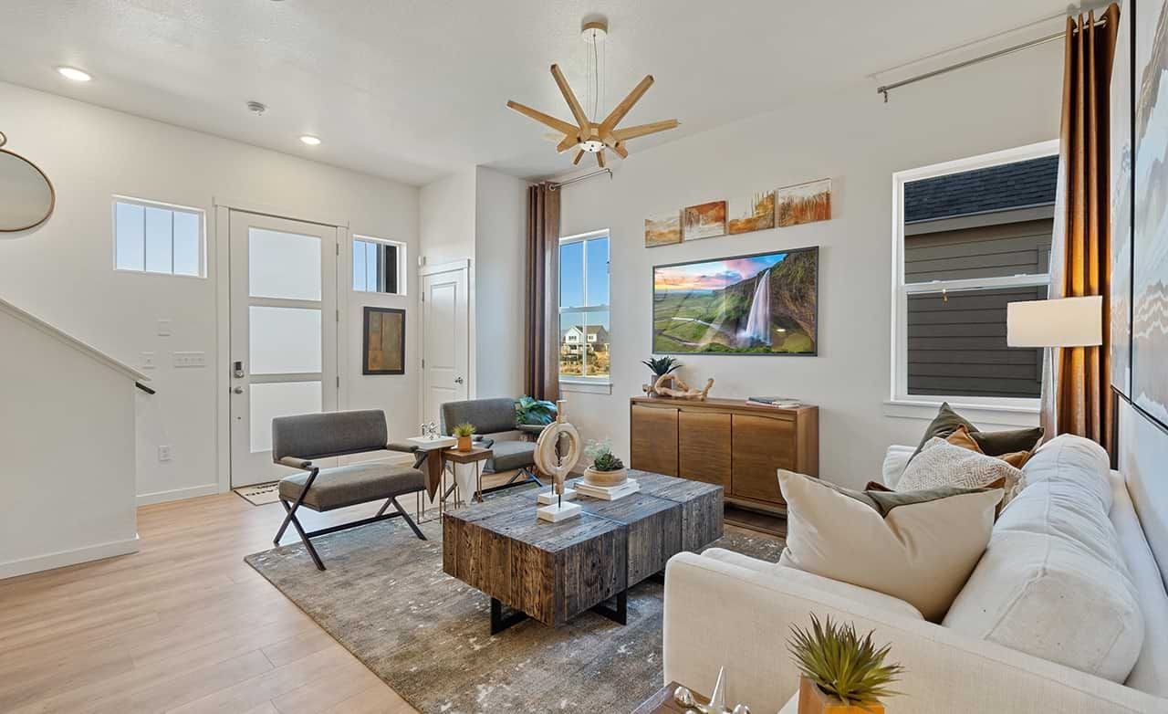 Sophisticated Living Room Design at Trailside on Harmony Modern living room features rustic wood coffee table, contemporary decor, Trailside on Harmony, stylish design.